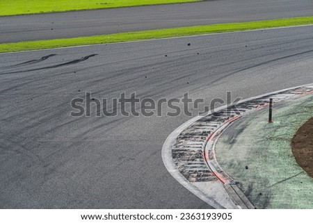 A race track with tire marks and tire debris left behind Royalty-Free Stock Photo #2363193905