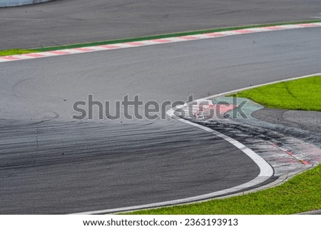 A race track with tire marks and tire debris left behind Royalty-Free Stock Photo #2363193913