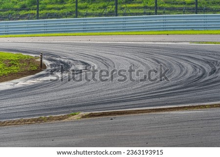 A race track with tire marks and tire debris left behind Royalty-Free Stock Photo #2363193915