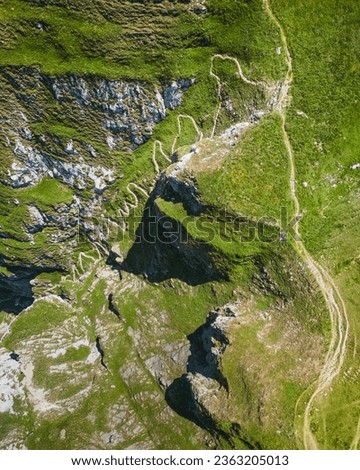 Drone top down view mountain roads hiking trails zig-zag landscape 