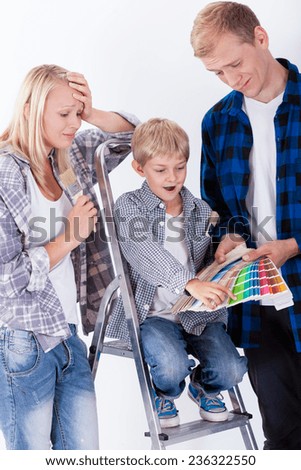 Child choosing green color for wall in his room