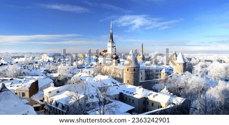 Panoramic aerial view of the old town of Tallinn, Estonia. St. Olaf's Church, fortress towers, snow-covered roofs and spires. Winter, Christmas vacations, travel destinations, sightseeing, culture Royalty-Free Stock Photo #2363242901