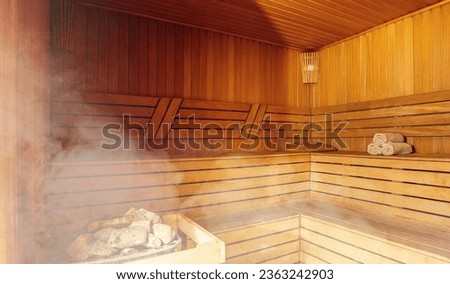 Interior of Finnish sauna, classic wooden sauna with hot steam. Russian bathroom. Relax in hot sauna with steam. Wooden interior baths, wooden benches and loungers accessories for sauna, spa complex. Royalty-Free Stock Photo #2363242903