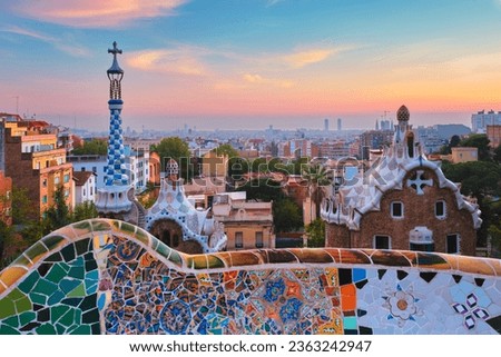 Barcelona city view from Guell Park with colorful mosaic buildings in tourist attraction Park Guell in the morning on sunrise. Barcelona, Spain Royalty-Free Stock Photo #2363242947