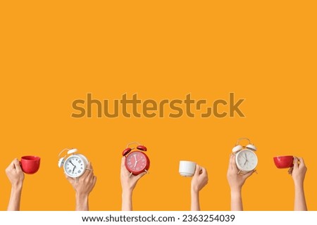 Hands holding different alarm clocks and cups on yellow background