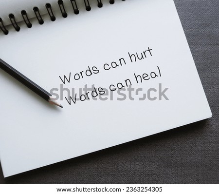 Notebook with handwritten text Words can hurt Words can heal - to remind language have power to harm or heal - word choice matters most so choose wisely Royalty-Free Stock Photo #2363254305