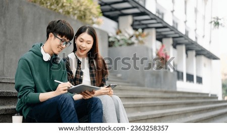 Asian Students are studying the campus park. Young people are spending time together. Reading book, working with laptop and tablet sitting on stairs 
 Royalty-Free Stock Photo #2363258357