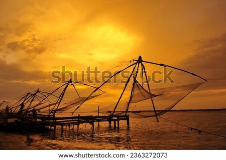 Traditional chinese fishing nets in Kochi, India at sunset  Royalty-Free Stock Photo #2363272073