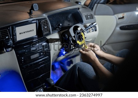 Professional car mechanic service Car steering wheel close up inside, maintenance airbag repair change problem part change new, test steering wheel, repair wiring sensor in workshop maintenance garage Royalty-Free Stock Photo #2363274997