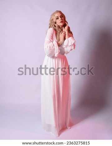 Full length portrait  of blonde woman  wearing white historical bridal gown fantasy costume dress.    Standing pose, facing forwards with gestural arms reaching out , isolated on studio background.