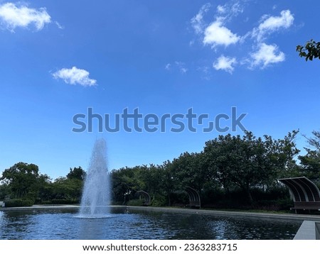 small lake with water fountain in summer tiem in hong kong
