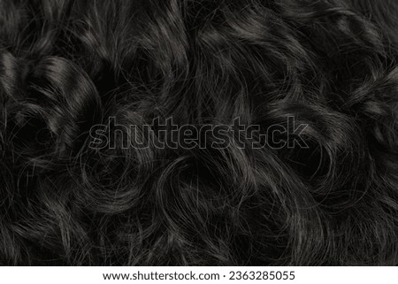 Close-up view of natural shiny dark hair, bunch of black brunette curls background Royalty-Free Stock Photo #2363285055