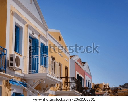 Symi Island, Greece. Greece islands holidays from Rhodos in Aegean Sea. Colorful neoclassical houses in bay of Symi close-up. Holiday travel background.