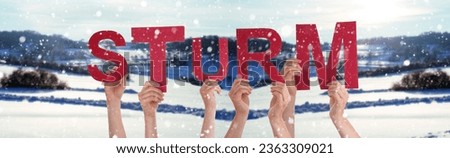 People Or Persons Hands Building German Word Sturm Means Storm. White Winter Background With Snowflakes And Snowy Landscape.