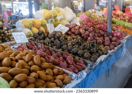 Pile of passionfruit, mangosteen, bell apples and other fruit for sale at a market stall, Thailand Royalty-Free Stock Photo #2363330899