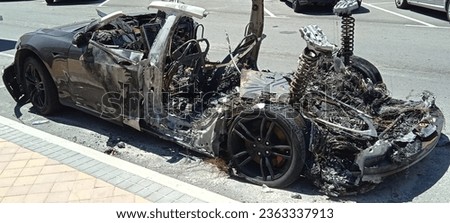 Electric car burned lithium battery danger fire insurance car accident Royalty-Free Stock Photo #2363337913