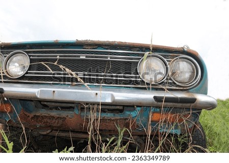 Old car abandoned in the grass

