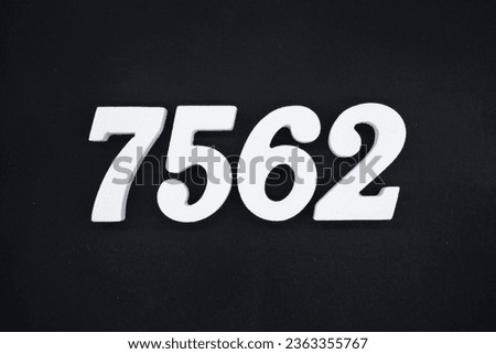 Black for the background. The number 7562 is made of white painted wood.