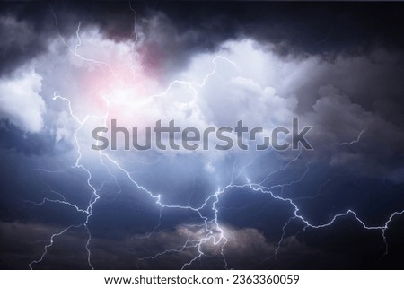 A dark cloudy sky with thunder lightning bolt strike close up. Weather and Nature background