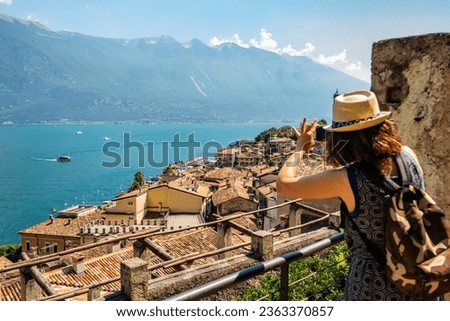 View of the lake from Limone castle with tourist taking pictures, Brescia, Italy