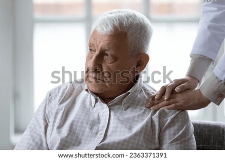 Supportive female caregiver comfort help upset lonely senior 80s male patient in retirement house, caring woman nurse support unhappy distressed mature man in hospital, elderly healthcare concept Royalty-Free Stock Photo #2363371391