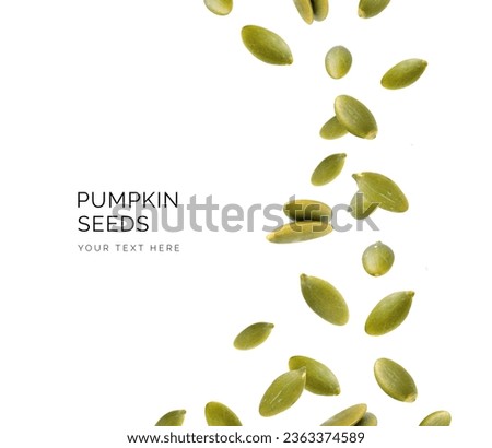 Creative layout made of pumpkin seeds on the white background. Flat lay. Food concept. Macro concept. 