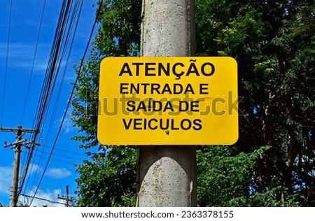 Warning sign in portuguese informing "Attention, entry and exit of vehicles", Ribeirao Preto, Sao Paulo, Brazil