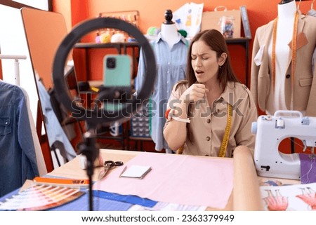 Beautiful brunette woman dressmaker designer recoding a tutorial feeling unwell and coughing as symptom for cold or bronchitis. health care concept. 