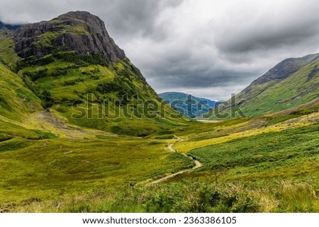 Spectacular mountain scenery with a stormy, grey sky in Glencoe, Scotland Royalty-Free Stock Photo #2363386105