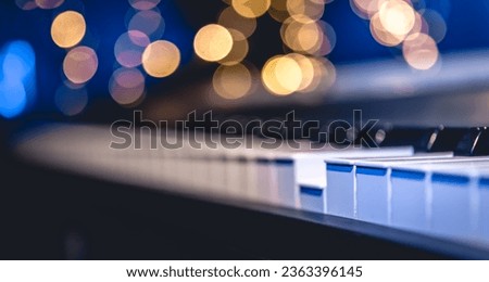 Piano keys close-up on a blurred background with bokeh.