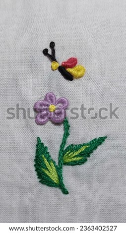 Hand embroidery flowers and butterfly.