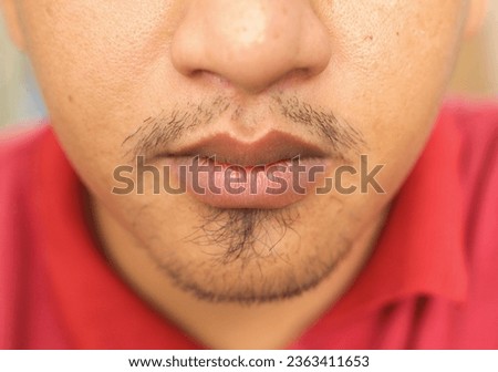 lips of asian man with thin mustache and beard Royalty-Free Stock Photo #2363411653