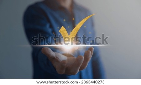 Businessman hand showing gold check mark digital technology icon symbol. Best quality assurance service concept, product performance assurance, and industry-leading ISO certification.