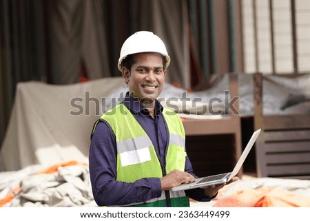 architecture, construction business and building concept - happy smiling male architect in helmet and safety west at site
