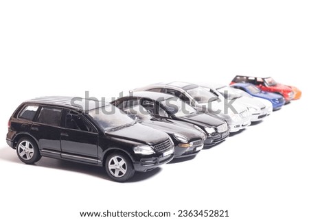 parking toy cars in a row isolated on white.
