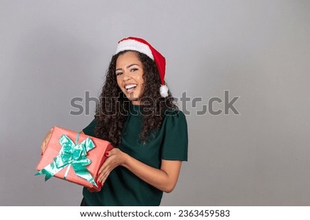 brazilian black woman, wearing christmas clothes, merry christmas, smiling, holding present.