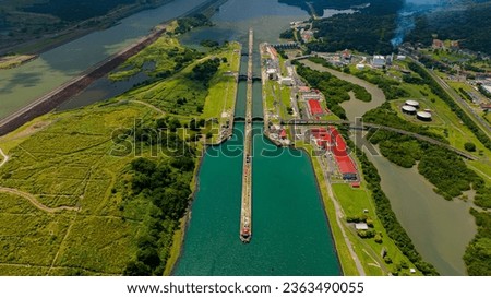 Panama Canal area view, container ship transit, water tanks, composed of locks Royalty-Free Stock Photo #2363490055