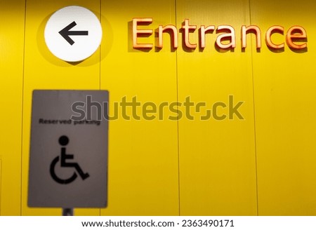 Front entrance of store with handicap sign in foreground 