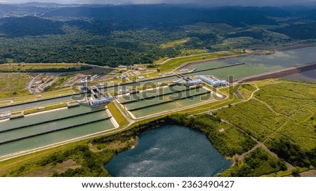 Panama Canal area view, container ship transit, water tanks, composed of locks Royalty-Free Stock Photo #2363490427