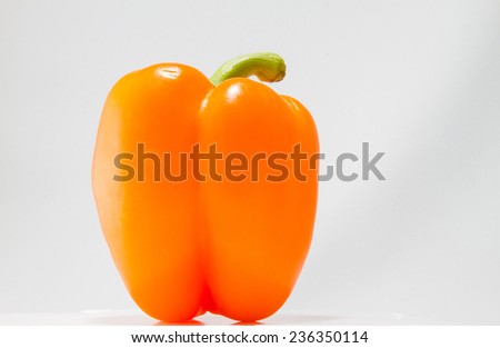 Orange pepper on a bright background