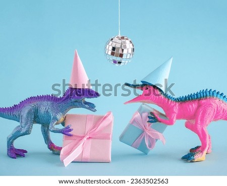 Two funky dinosaurs with gift boxes and disco ball on pink background. Happy birthday card idea.