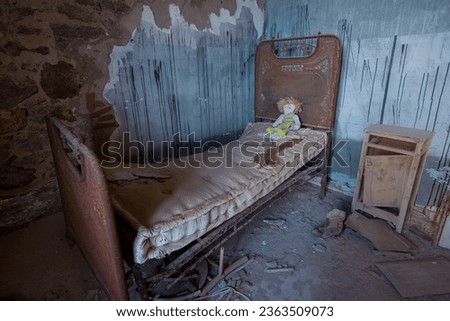 Metal beds with creepy dolls inside abandoned orphanage Royalty-Free Stock Photo #2363509073