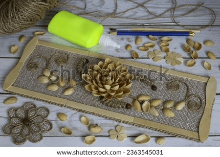 Craft from pistachio shells with accessories for making a composition with a pistachio flower, homemade product for developing fine motor skills and teaching children