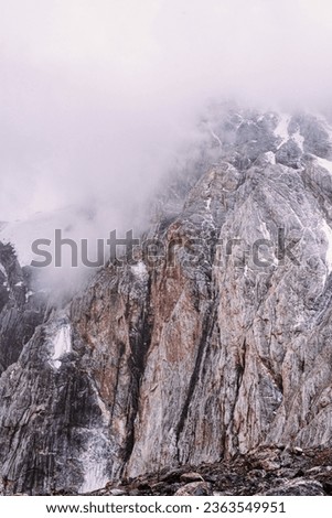 Misty cliffs and rocks on a pass in the Fann Mountains in Tajikistan. High quality photo