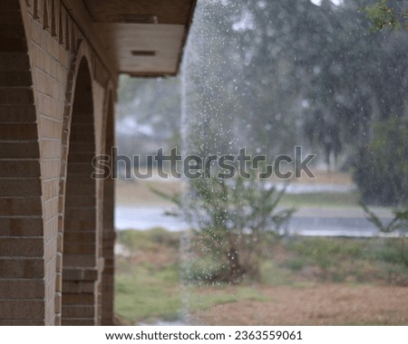 poruing rain running off the roof Royalty-Free Stock Photo #2363559061