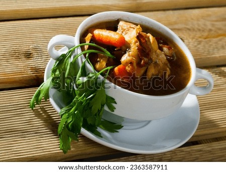 Scottish soup dish on peppered chicken stock with leeks, carrots and parsley (Cock-a-leekie) served on white plate.. Royalty-Free Stock Photo #2363587911