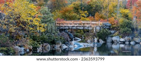 Walking bridge in scenic water fall Frederik Meijer gardens in autumn time in Grand Rapids, Michigan. Royalty-Free Stock Photo #2363593799