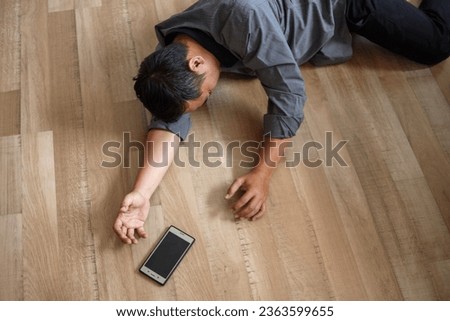 Unconscious young man lying on floor with epileptic seizures at home, male injure at home. Royalty-Free Stock Photo #2363599655