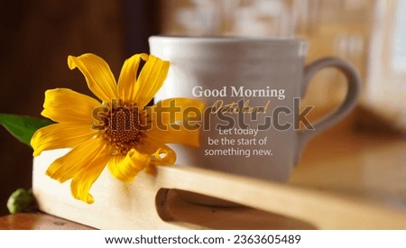 Morning a white cup of coffee or tea with yellow flower and morning greeting text - Good Morning October. Let today be the start of something new. Hello October concept with autumn color background.