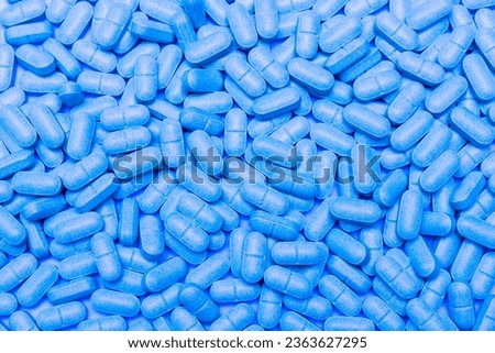 Seamless pattern with blue medical tablets. Medicine vector illustration with pharmaceutical capsules for illness and pain treatment. Design for background or wallpaper.